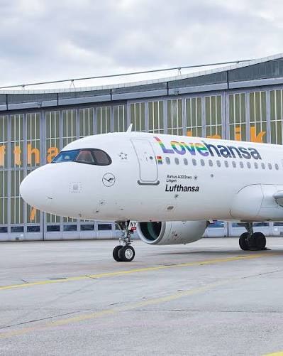 Lufthansa Airbus A320neo D-AINY in the rainbow Lovehansa livery, parked at the gate